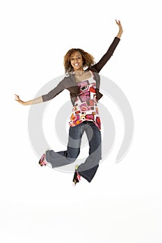 Full Length Studio Portrait Of Jumping Teenage Gir