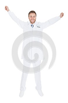 Successful Young Male Doctor With Arms Raised