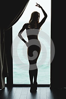 Full length of tempting beautiful young woman silhouette