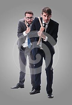 Full length . two businessmen pulling a long rope.