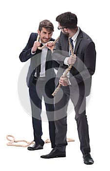 full length . two businessmen pulling a long rope.