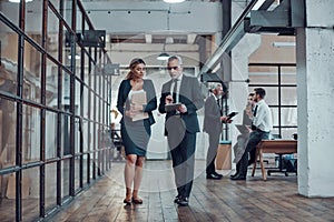 Full length of two colleagues in elegant formalwear