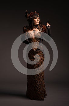 Full length view of brunette woman in gothic steampunk gown