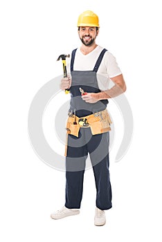 full length view of handsome repairman holding tools and smiling at camera