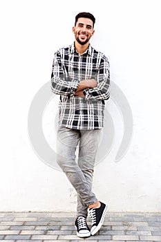 Full length young arabic man smiling against white background