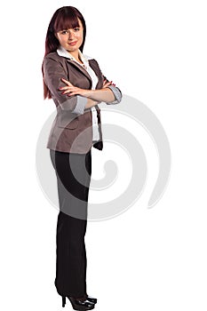 Full length of young business woman standing with arms folded