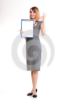 Full length young business woman standing with her clipboard iso