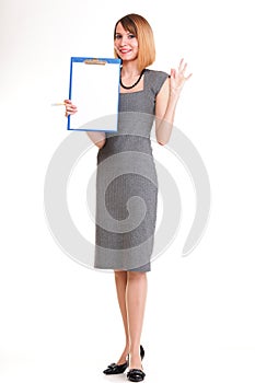 Full length young business woman standing with her clipboard iso