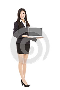 Young businesswoman holding laptop