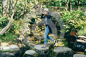 Young girl walking in nihon teien on sunny day photo