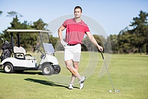 Full length of young golfer with hand on hip