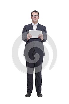 Full lenth portrait of cool businessman using electronic tablet and looking at camera