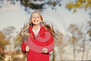 Full of life energy. Child cheerful on fall walk. Warm coat best choice for autumn. Autumn outfit concept. Kid girl wear