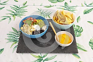 Full Mexican menu of black beans with pulled chicken, queso fresco, avocado, photo