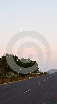 Full Moon above Indian Road with Rural Landscape in Early Morning