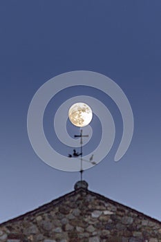 Full moon backlit, over Sant Joan de Caselles Church, Canillo. Andorra. photo