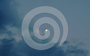 Full moon on bright sky in evening