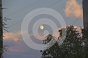 Full moon and clouds in the late evening