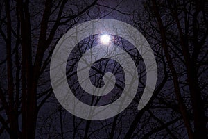 Full moon in cloudy sky at night