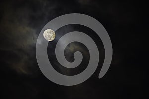 Full moon in the middle of clouds