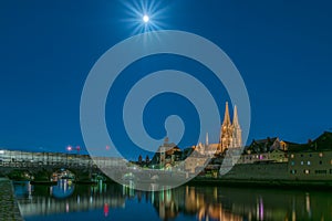 Full moon Night in Regensburg Bavaria with view to Dome St. Peter, stone Bridge and River Danube