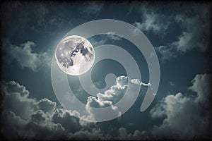 Full moon in the night sky with clouds dark natural background