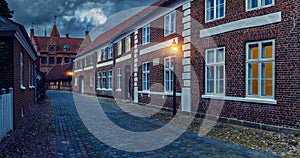 Full moon over the cobblestone street of the old town