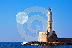 Full moon over Lighthouse of Chania at summer sunse