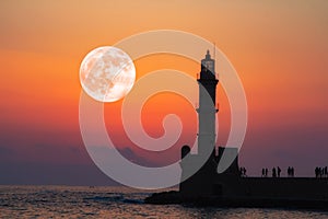 Full moon over Lighthouse of Chania at summer sunse