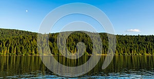 Full moon over mountain lake