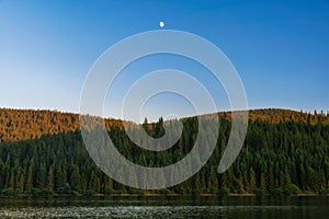 Full moon over mountain lake