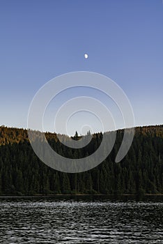 Full moon over mountain lake