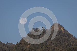 Full moon over mountains in northern Thailand