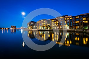 The full moon over a waterfront apartment building in Fells Point, Baltimore, Maryland.