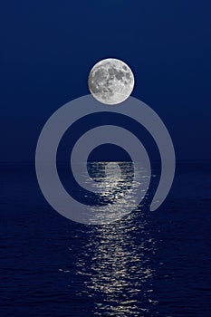 Full moon reflection over the evening sea in Spanish Costa Brava