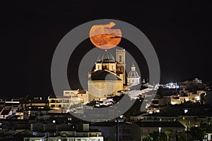 Full moon rise over town, in Atea, Alicante, Spain