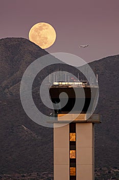 Full Moon Rises Over Air Traffic Control Tower and McDowell Mountain Range