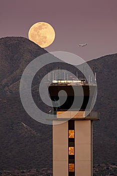 Full Moon Rises Over Air Traffic Control Tower and McDowell Mountain Range photo