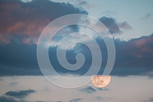 Full Moon Rising In Cloudy Evening Sky