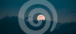 Full Moon Rising In Cloudy Evening Sky