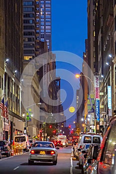 Full moon rising over night skyline of New York