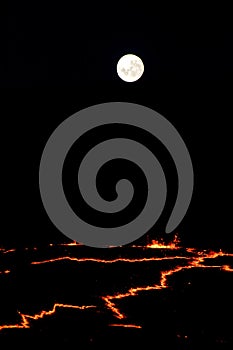 Full moon rising over the rim of Erta Ale volcano in Ethiopia