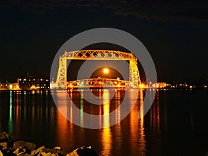 Full moon is seen through the iconic Duluth Minnesota aerial lift bridge