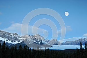 Full Moon set over the Canadian Rockies photo