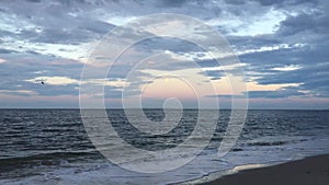 Full Moon Setting during Sunrise on July 4th at Beach in Far Rockaway in New York, NY.