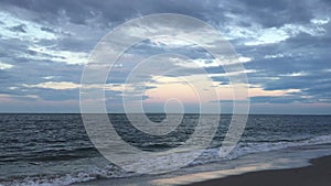 Full Moon Setting during Sunrise on July 4th at Beach in Far Rockaway in New York, NY.