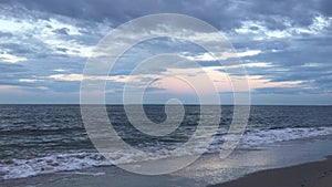 Full Moon Setting during Sunrise on July 4th at Beach in Far Rockaway in New York, NY.