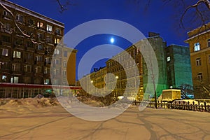 Full moon on a winter night above city street