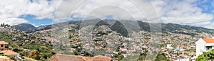 Full panoramic view of the high lands on city of Funchal and Camara de Lobos, mountains as background, on the island of Madeira,