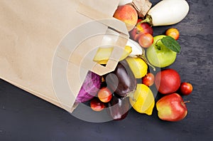 Full paper bag with different vegetables and fruits